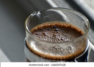 A Close Up Of A Cafetiere Brewing Coffee On A Kitchen Window Ledge