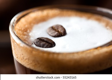 Close Up Of Caffe Macchiato With Coffee Beans