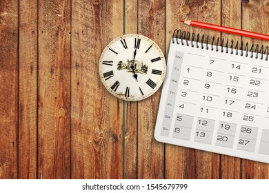 close up of calendar and alarm clock on the table, planning for business meeting or travel planning concept