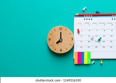 close up of calendar and clock on green background, planning for business meeting or travel planning concept