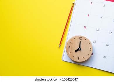 close up of calendar or monthly planner on the yellow background, planning for business meeting or travel planning concept