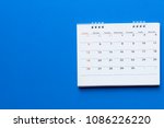 close up of calendar on blue background planning for business meeting or travel planning concept