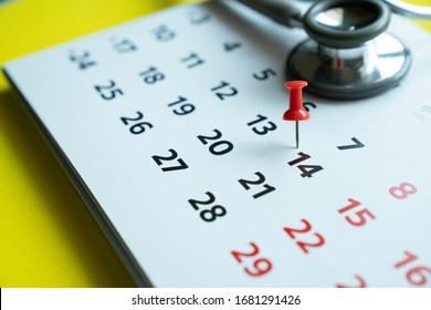 Close Up Of Calendar And Stethoscope For Covid-19, Corona Virus Epidemic Worldwide That People Must Do Social Distancing For 14 Days Concept