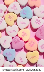 Close up of Candy hearts on pink background, background photo for valentine's day, valentines concept, anniversary, holidays, relationships, love