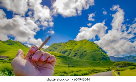 Close Up Cannabis Blunt With Beautiful Landscape