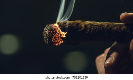 Close of up a cannabis blunt being smoked.