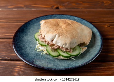 Close Up Of Canned Tuna Pita With Cucumber, Tuna Sandwich On A Wooden Table And Blue Clay Plate