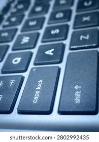 Close up of caps lock and shift key on laptop keyboard, concept of emphasis, digital communication, and business statement