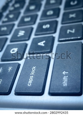 Close up of caps lock and shift key on laptop keyboard, concept of emphasis, digital communication, and business statement