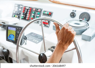 Close Up Captain Hand On Boat Steering Wheel