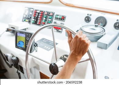 Close Up Captain Hand On Boat Steering Wheel