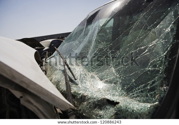 Close up of\
car with broken windshield at\
junkyard