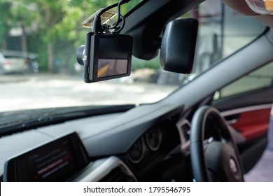 Close Up Of Car Camera Mount On Windshield. Car Camcorder Is Onboard Camera That Records The View Through A Vehicle's Front Windscreen. Dashcams Can Provide Video Evidence In Event Of A Road Accident.