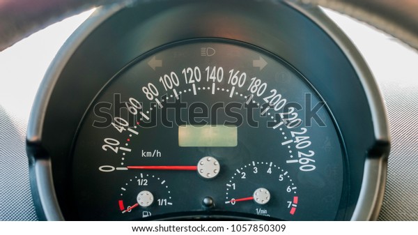 Close up of car\
dashboard cluster or Instrument panel with speedometer in km\'h, rpm\
gauge, and fuel tank\
gauge.