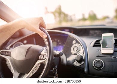 Close Up Of A Car Dashboard With Navigation In Smart Phone