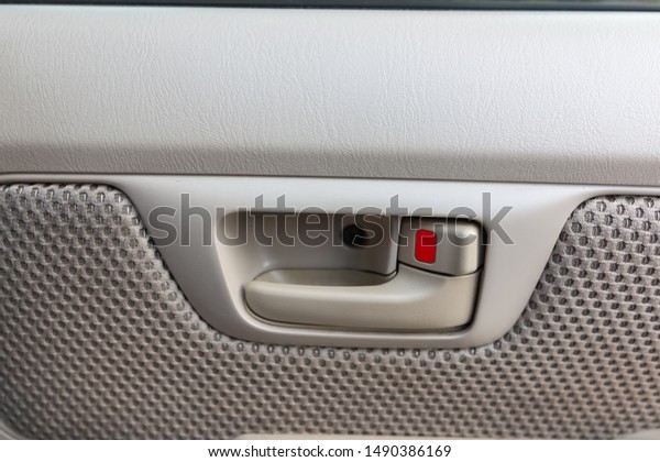 Close up car door open button,Modern\
car door panel with handle,Modern car interior\
details