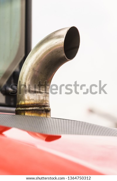 Close up of car exhaust chimney on\
gray sky background. Metal big vehicle truck tractor\
details.
