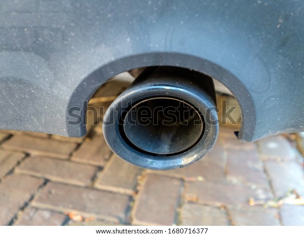 Close\
up of a car exhaust without fumes. Selective\
focus