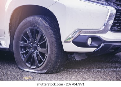 Close Up Of A Car Flat Tire, Air Tire Pressure Lose On The Road.