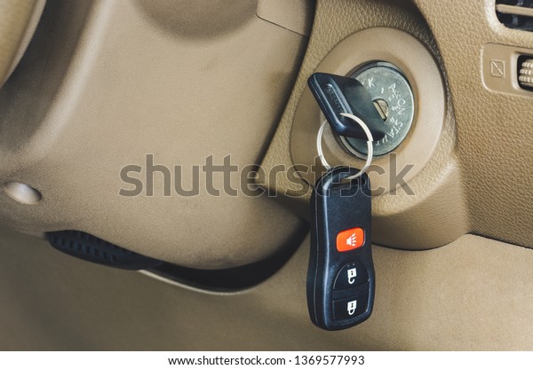 close up\
of car key with remote control  in keyhole\

