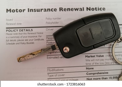 Close Up Of Car Key In Sharp Focus On Top Of A Motor Insurance Renewal Form Intentionally Blurry