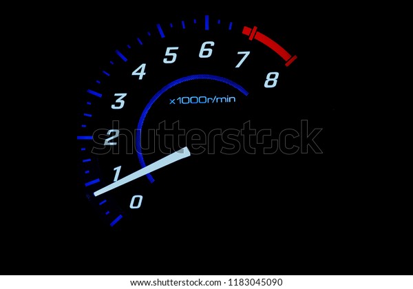 close up of car\
meter with black\
background