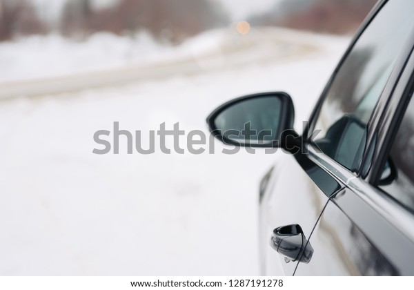 Close
up of car mirror with reflection of behind the
car.