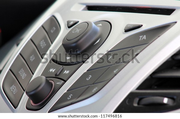 Close up of car music control panel . Volume and\
various buttons .
