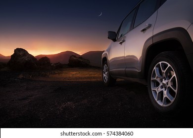 Close Up Of A Car On A Desert Road At The Sunset With Copy Space