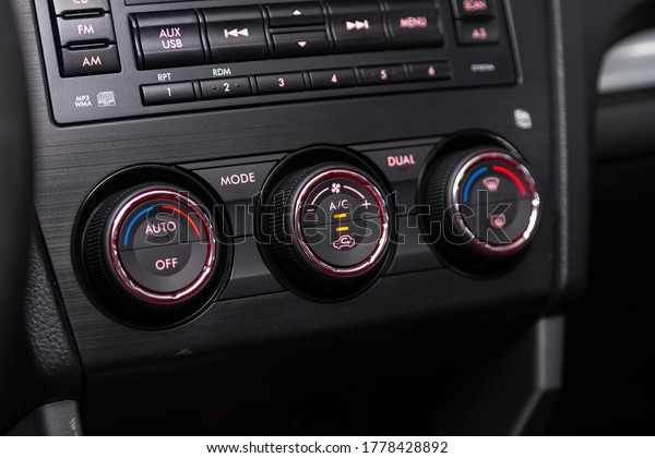 close up of  car panel with the air conditioning
button inside a car.
