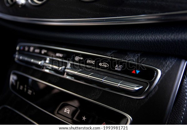 close up of car panel with the air conditioning\
button inside a car.