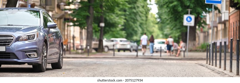 Close Up Of A Car Parked On City Street Side.