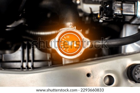Close up of car radiator cap with temperature water gauge and shows the overheating of the radiator in the engine compartment, Car maintenance service concept.