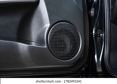 Close up car speaker on car door panel. Car audio system concept.