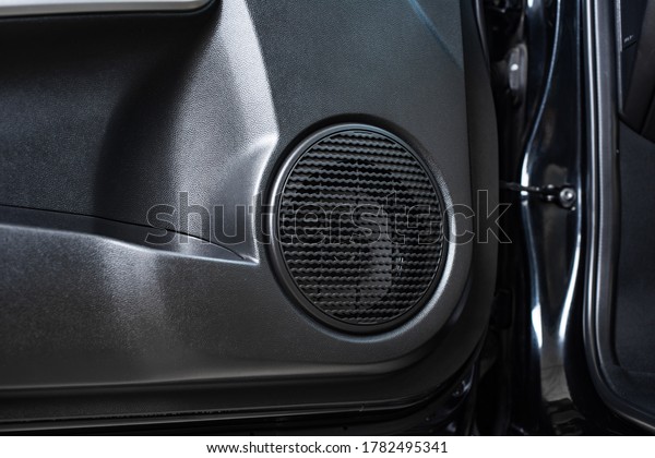 Close up car speaker on car door panel. Car\
audio system concept.