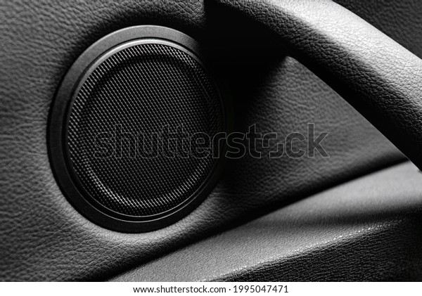 Close up car speaker on car door panel. Car\
audio system concept.