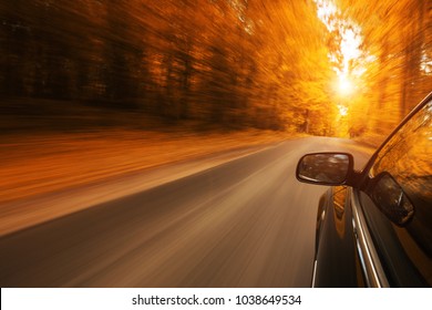 Close Up Of A Car Speeding On The Empty, Autum Road With Copy Space