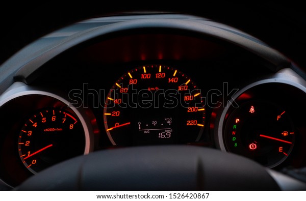 Close up of car speedometer with the needle\
pointing at  0 kmp on black\
blackground