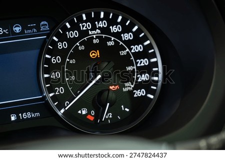 Close up of car speedometer with warning lights.