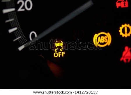 Close up of car speedometer  with yellow warning sign