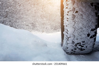 Close Up Of Car Tire On The Snowy Road With Copy Space