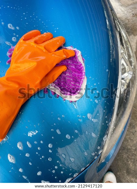 Close up of car\
wash and rubber gloves\
orange
