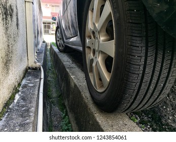 Close Up Of A Car Wheel Parking Very Near To A Drain