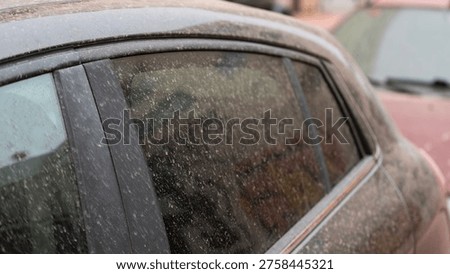 Close up of car window covered with dried mud and dust after rain showing dirty surface and texture on vehicle exterior