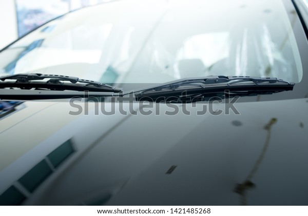 close up of car windshield rain wipers And\
close-up images of the windshield or windshield New cars parked in\
the showroom