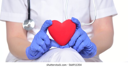 Close Up Of Cardio Heart Surgeon Hands Holding Red Heart Shape On White Background