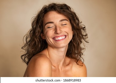 Close Up Of Carefree Young Woman Laughing. Portrait Of Smiling Woman With Freckles And Closed Eyes Enjoying Beauty Treatment. Beautiful Girl Laughing Isolated On Background With Copy Space, Skin Care.