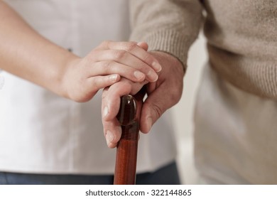 Close Up Of Carer Holding Old Man Hand