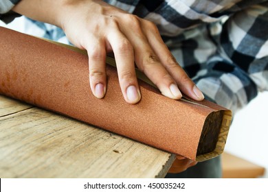 Close Up Carpenter Hand Using Sandpaper On Wood