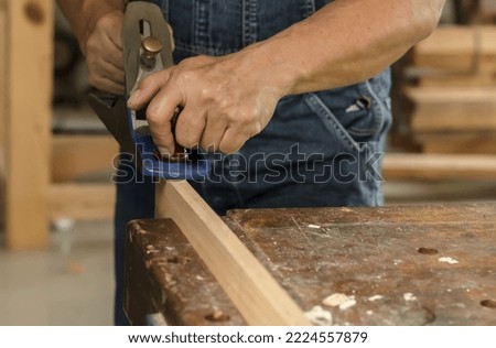 Close up carpenter man hands using manual carpentry tools working with wood plank in wood working shop